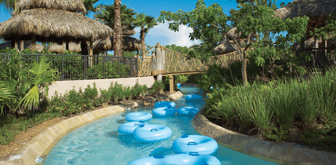 Several blue inner-tubes float down a lazy river at Hyatt Residence Club Bonita Springs, Coconut Plantation, one of the best Florida hotels with water parks or a lazy river on the Gulf Coast for families.