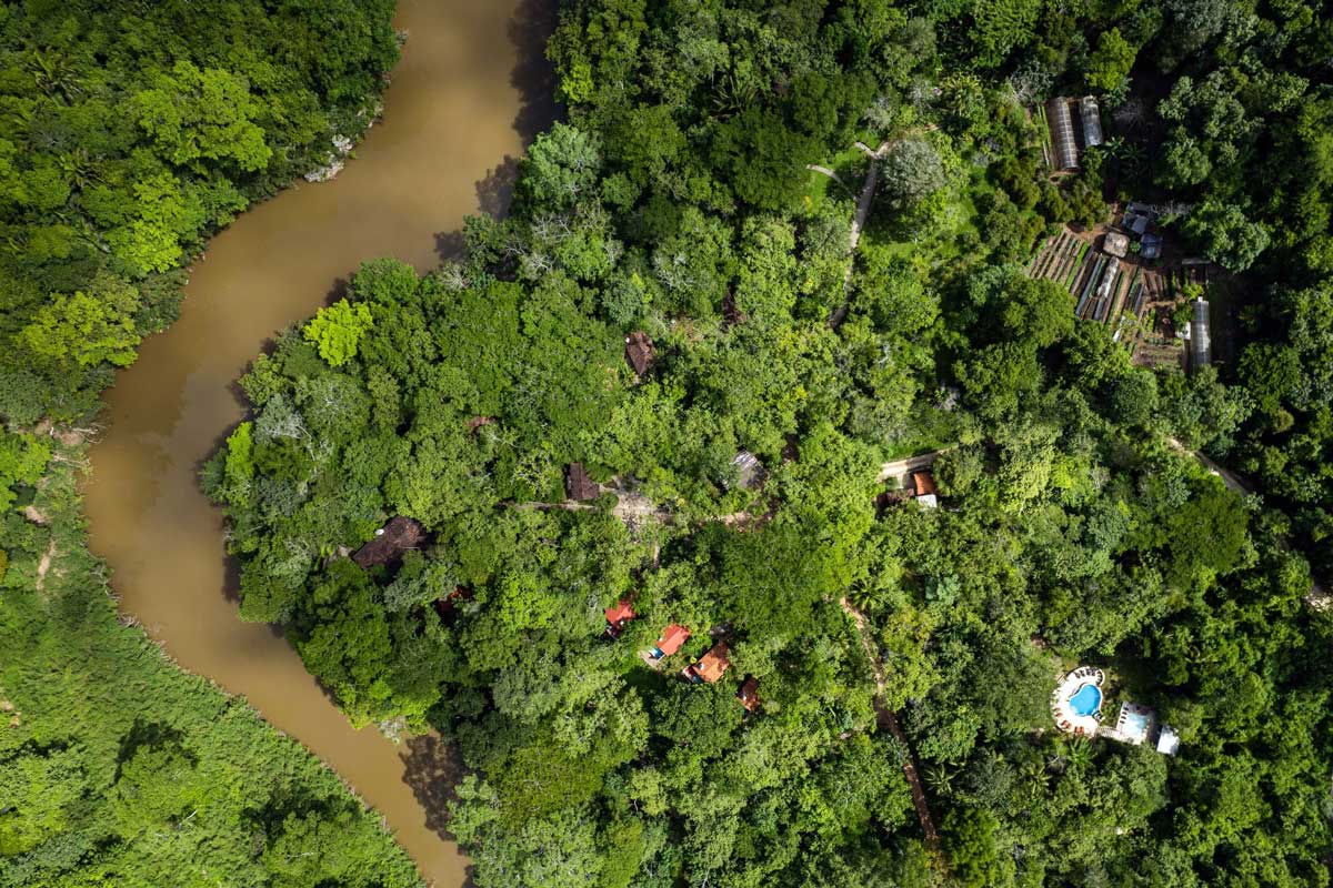 An aerial view of the grounds at Mystic River Resort, nestled along a river in Belize.