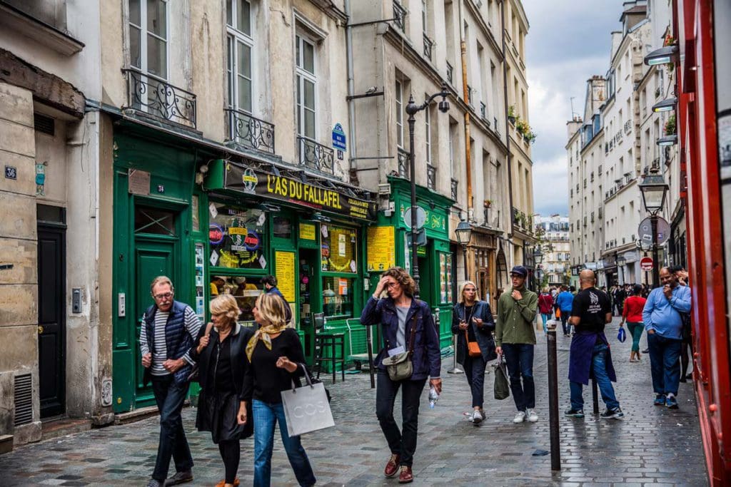 People milling about Rue des Rosiers in Paris.