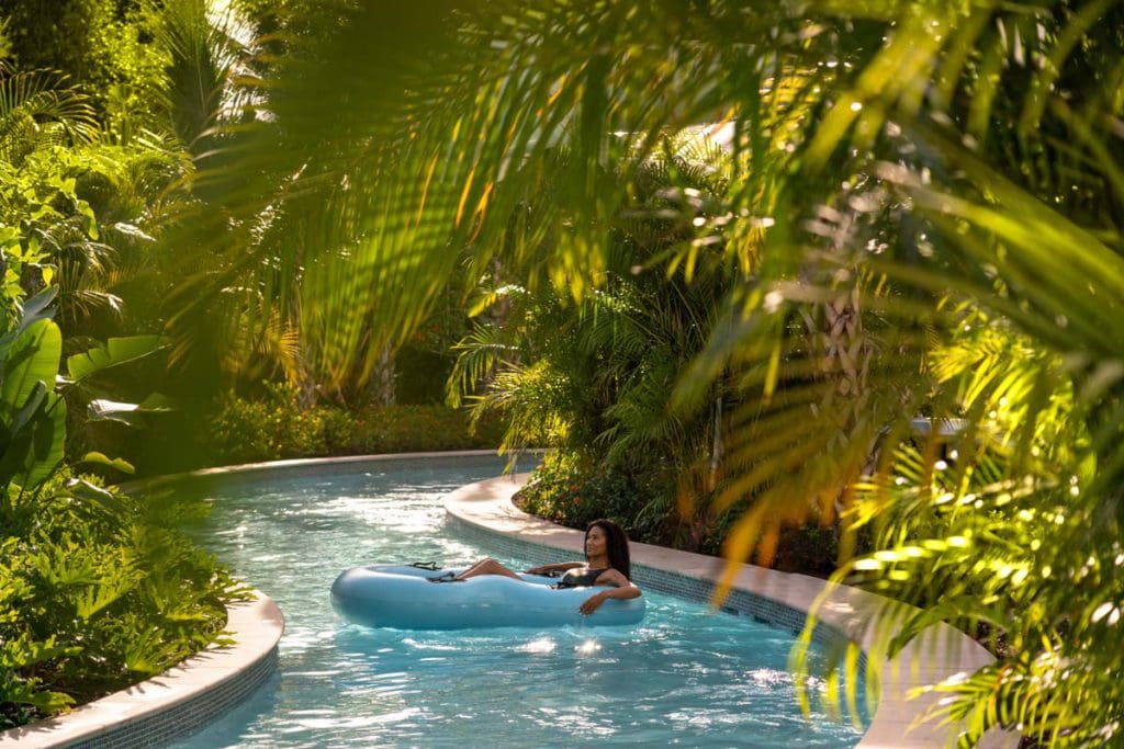A woman floats down the lazy river at The Ritz-Carlton Naples, Tiburón.