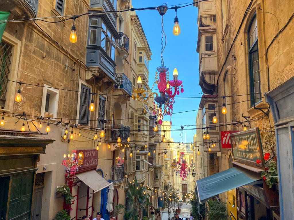 A charming city street, lit up at night, in Malta.