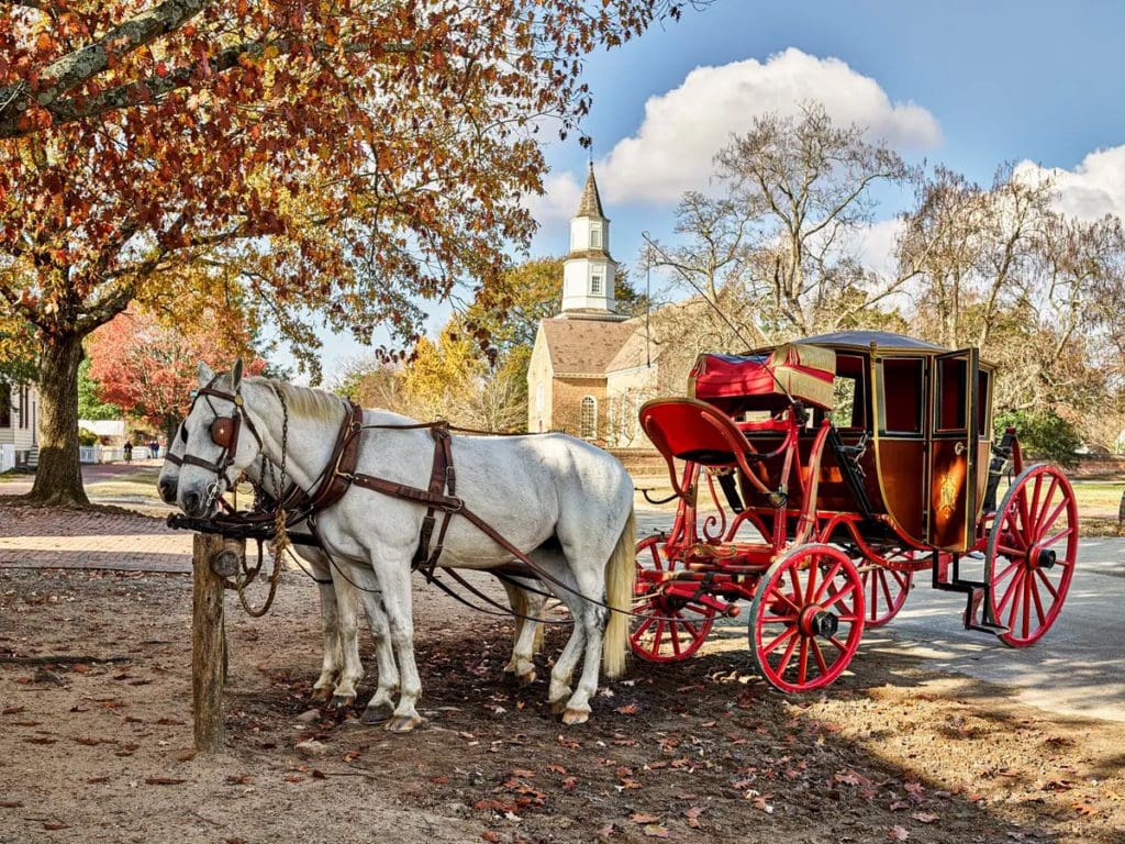 A horse-drawn carriage stands empty in a fall scene in Williamsburg, Virginia, one of the best Memorial Day Weekend getaways from Washington DC for families.