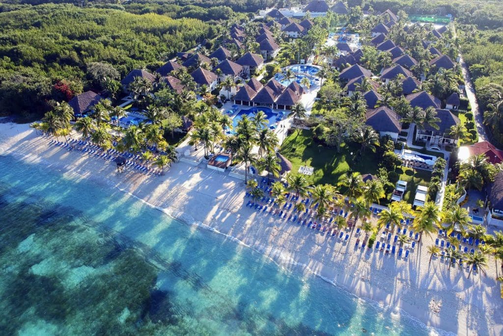 An aerial view of Allegro Cozumel, along the turquoise waters and beach of the ocean at one of the best resorts in Mexico with a water park for families.