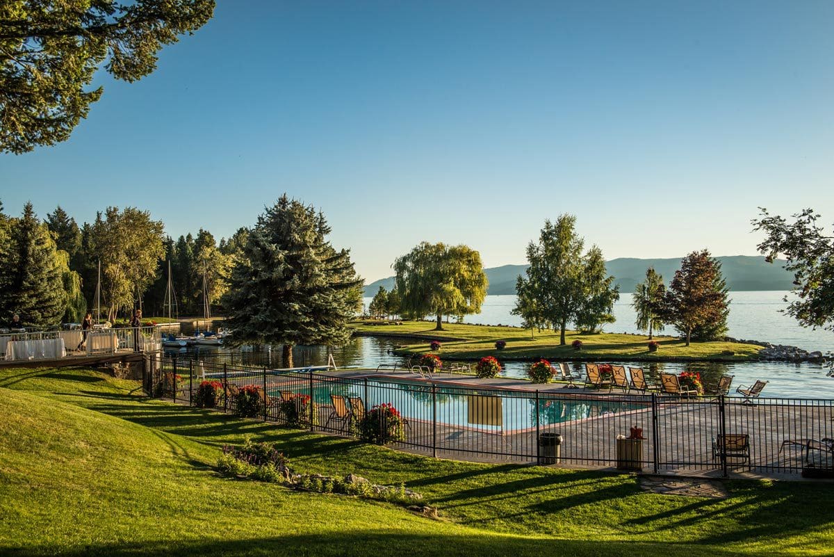 The calm lake and surrounding area, with seating available, at Flathead Lake Lodge, one of the best all-inclusive hotels in the United States for families.