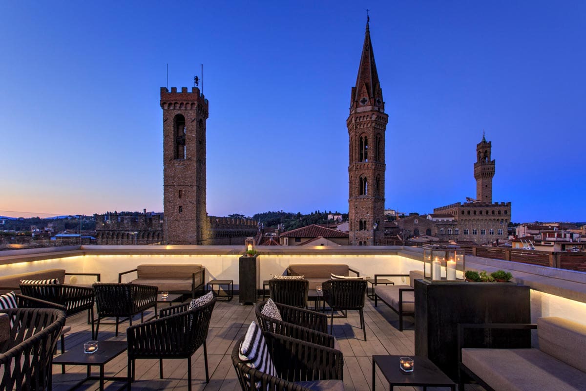 The rooftop terrace of Grand Hotel Cavour, overlooking Florence at night.