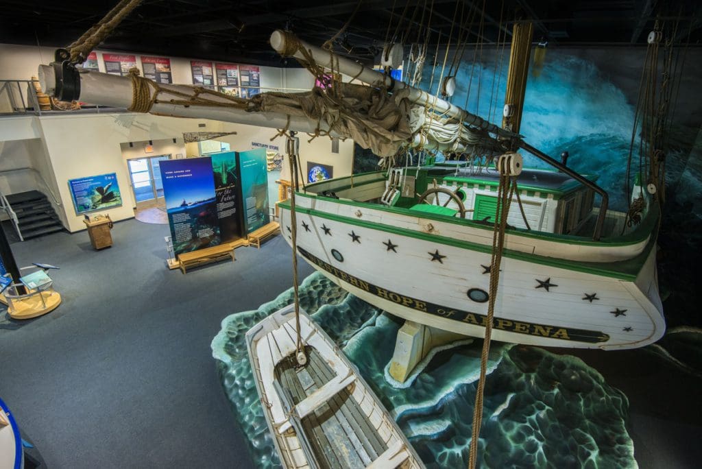 Inside an exhibit at Great Lakes Maritime Heritage Center, featuring a boat and other marine information areas at one of the best places in Michigan to visit with kids.