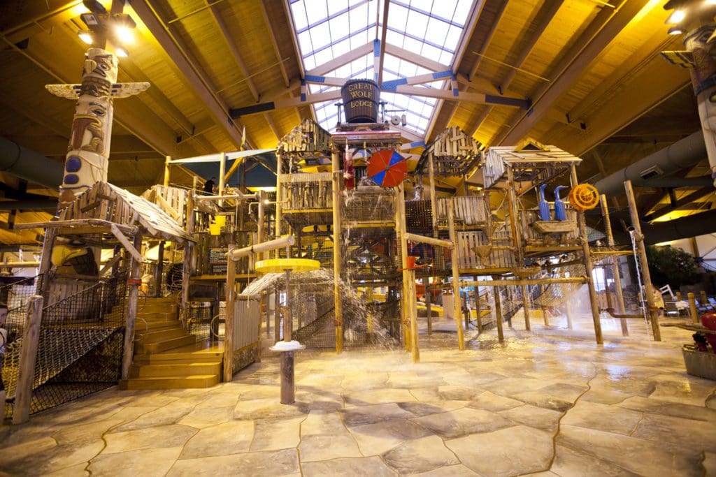 The large indoor water park, featuring a woodsy theme, at Great Wolf Lodge Traverse City, one of the best places in Michigan to visit with kids.