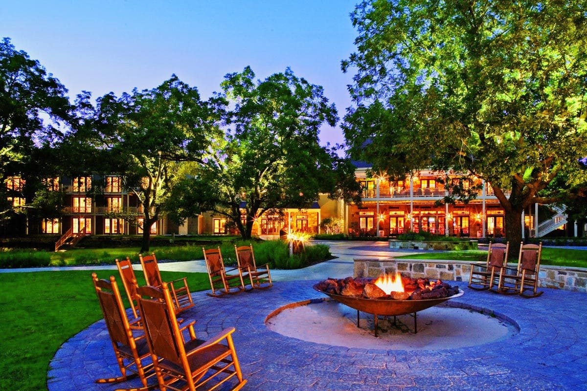 Several empty chairs sit around a fire pit at Hyatt Lost Pines Resort and Spa.