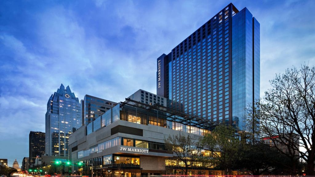 An exterior view of JW Marriott Austin at dusk, one of the best hotels in Austin for families.