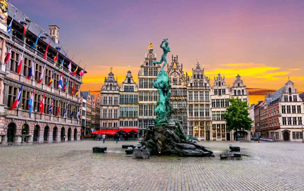 The market square in Antwerp, with a vibrant sunset in the distance at one of the best places in Belgium for families.