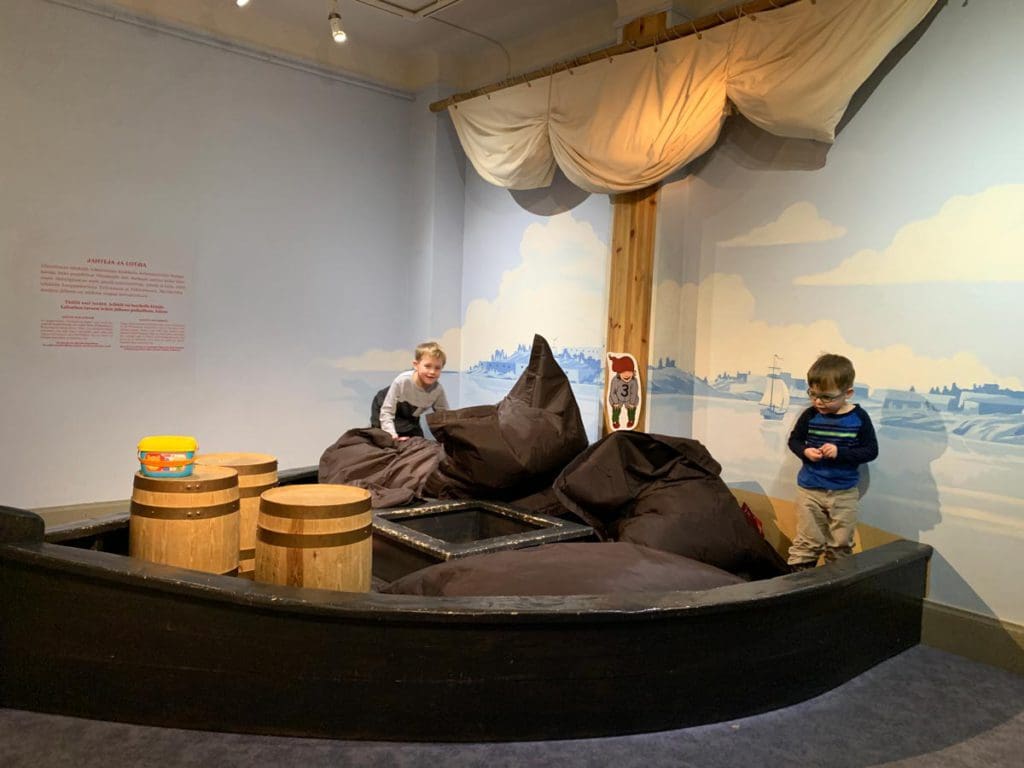 Two kids play in a Viking-inspired exhibit at Children's Town in Helsinki, a must stop on our Finland winter itinerary for families.