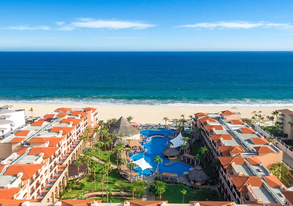 An aerial view of the large resort buildings, pools, and beach of Royal Solaris Los Cabos, one of the best resorts in Mexico with a water park for families.