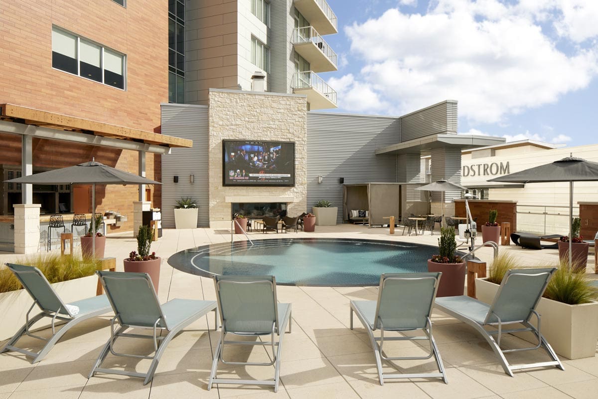 The circular outdoor pool and surrounding pool deck at Archer Hotel Austin.