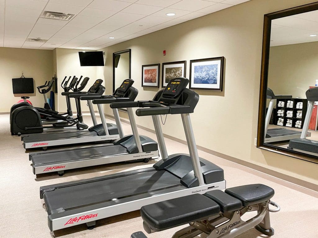 Inside the fitness center at Staybridge Suites Eau Claire - Altoona, featuring several treadmills.