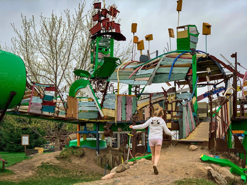A young girl runs toward an art installation at the Franconia Sculpture Park, one of the best places to explore near the Twin Cities with kids.