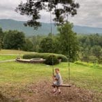 A young boy swings on a tree swing, while staying at Blackberry Farm.