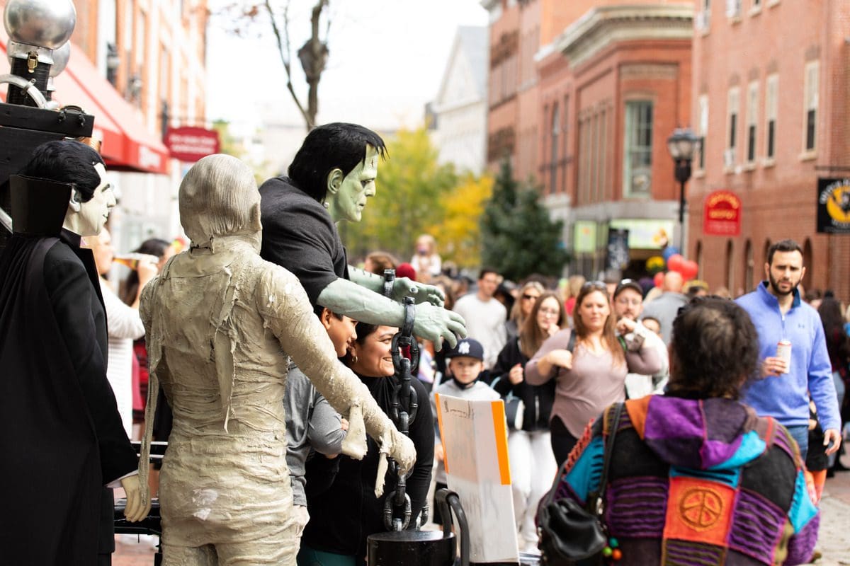 Several people are dressed in Halloween costumes for a parade in Salem.