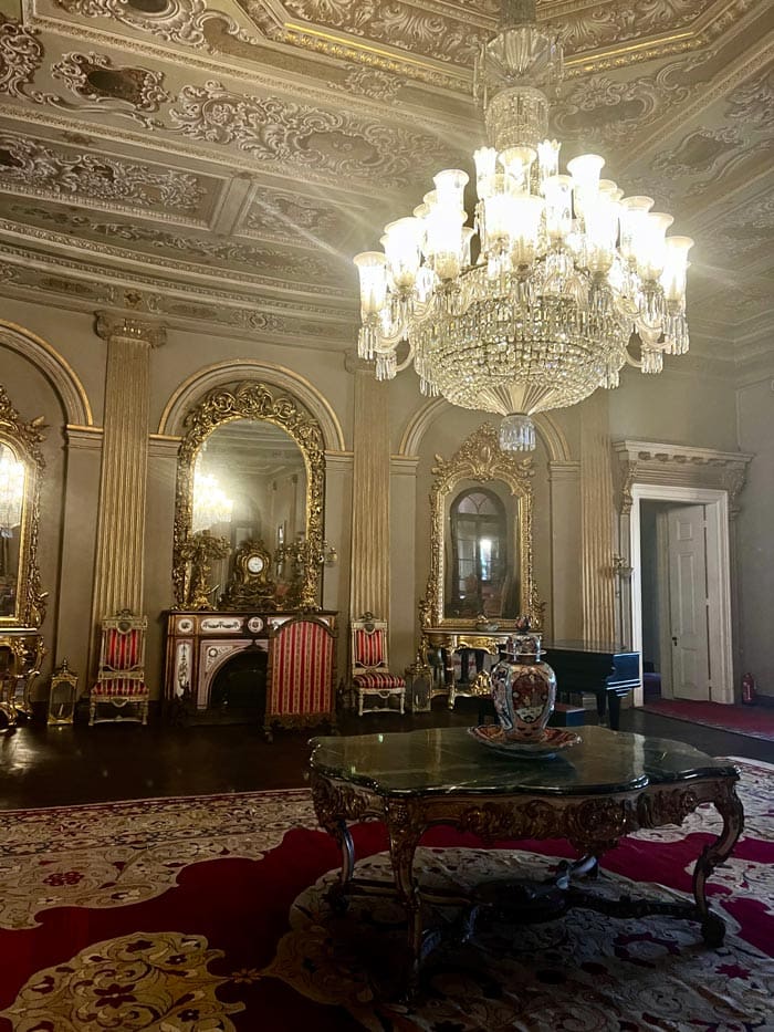 An interior room at the Dolmabahçe Palace, featuring a large table and grand chandelier. 