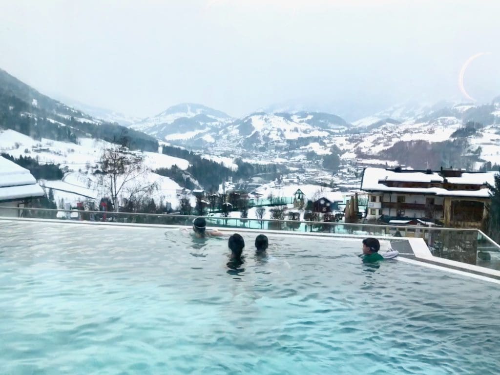Kids swim in a heated pool at their hotel, after a long day of family skiing in Alpendorf.
