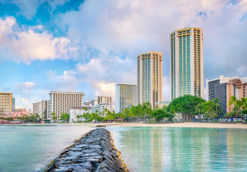 A break-wall stretches toward the sprawling property of Hyatt Regency Waikiki Beach Resort and Spa.