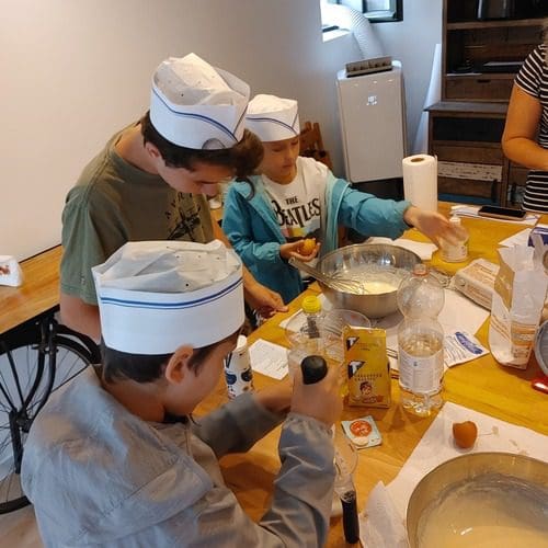 A family makes waffles in a workshop in Bruges.