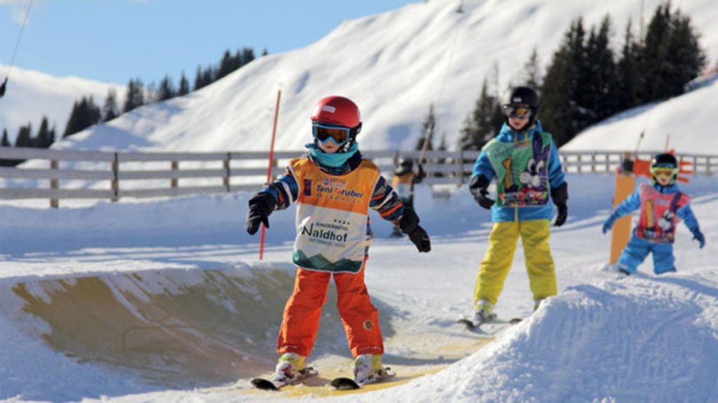 Kids make their way down the Kinder Pipe during ski lessons at The Toni Gruber Ski School.