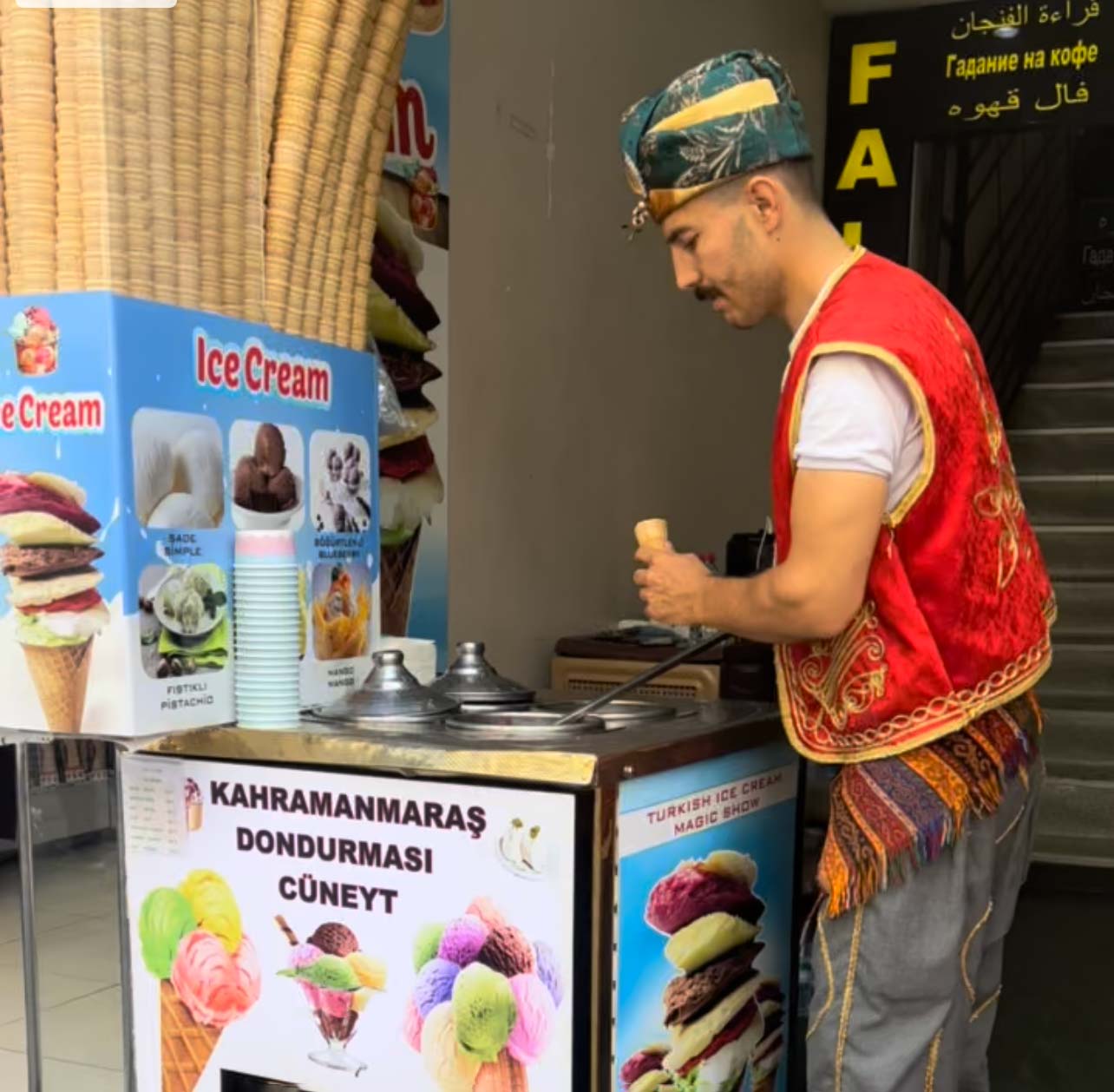A man scoops ice cream from a cart in Istanbul.