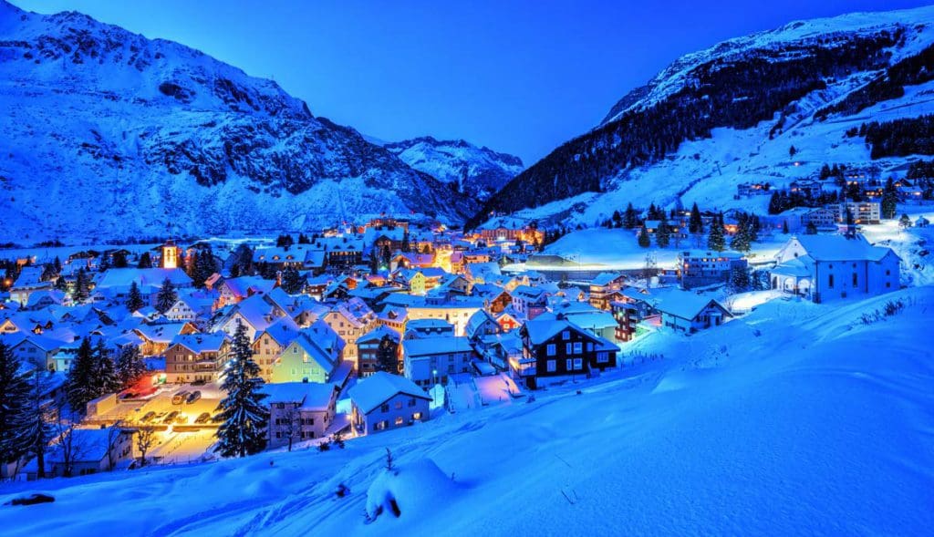 An aerial view of Andermatt, nestled in the Swiss Alps, one of the best places to ski Europe with Kids.