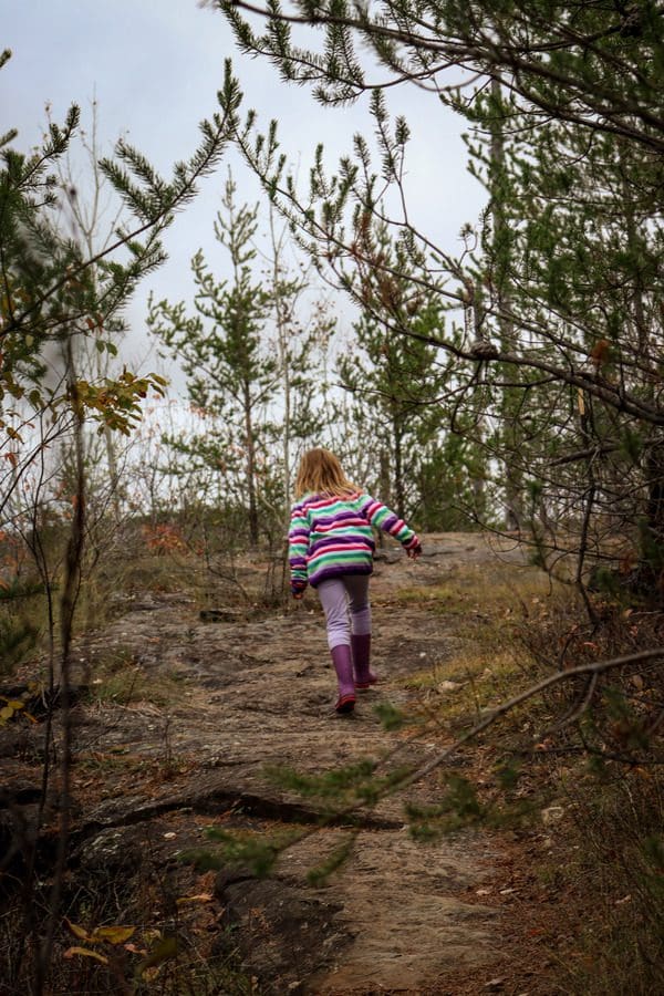 A young girl hikes along a path on Magnetic Rock Trail, one of the best places to visit in northern Minnesota with kids.