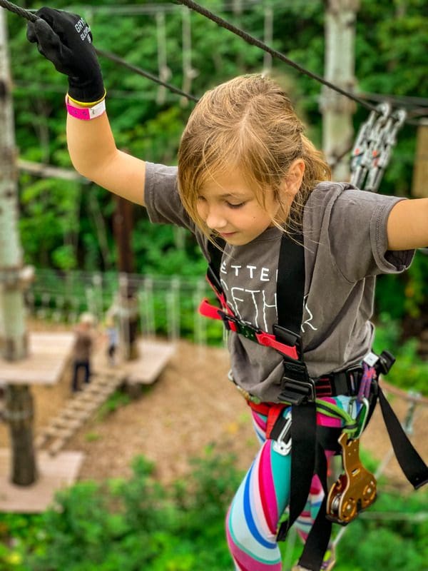 A young girl moves along a course at the North Shore Adventure Park near Silver Bay, one of the best places to visit in northern Minnesota with kids.