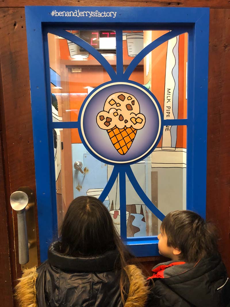 Two young kids look at an exhibit while touring Ben & Jerry’s Ice Cream Factory.