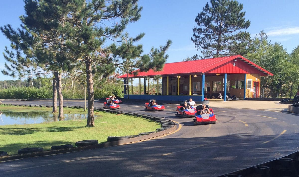 Kids zoom around an outdoor go-kart race track at Northland Kart Kountry in Brainerd, one of the best places to visit in northern Minnesota with kids.