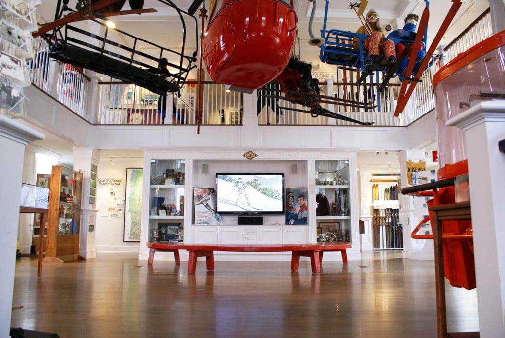 The lobby of Vermont Ski & Snowboard Museum, with a model gondola overhead, one of the best indoor things to do when skiing in Stowe with kids.