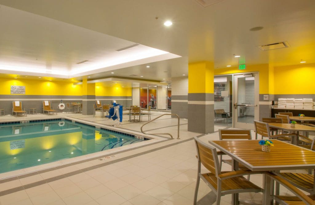 The indoor pool area and surrounding pool deck at Hampton Inn & Suites Denver Downtown-Convention Center, one of the best Denver hotels for families.