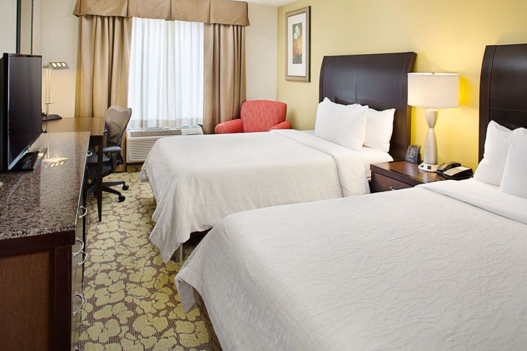 Inside one of the standard guest rooms at Hilton Garden Inn Denver Tech Center, featuring two queen beds.