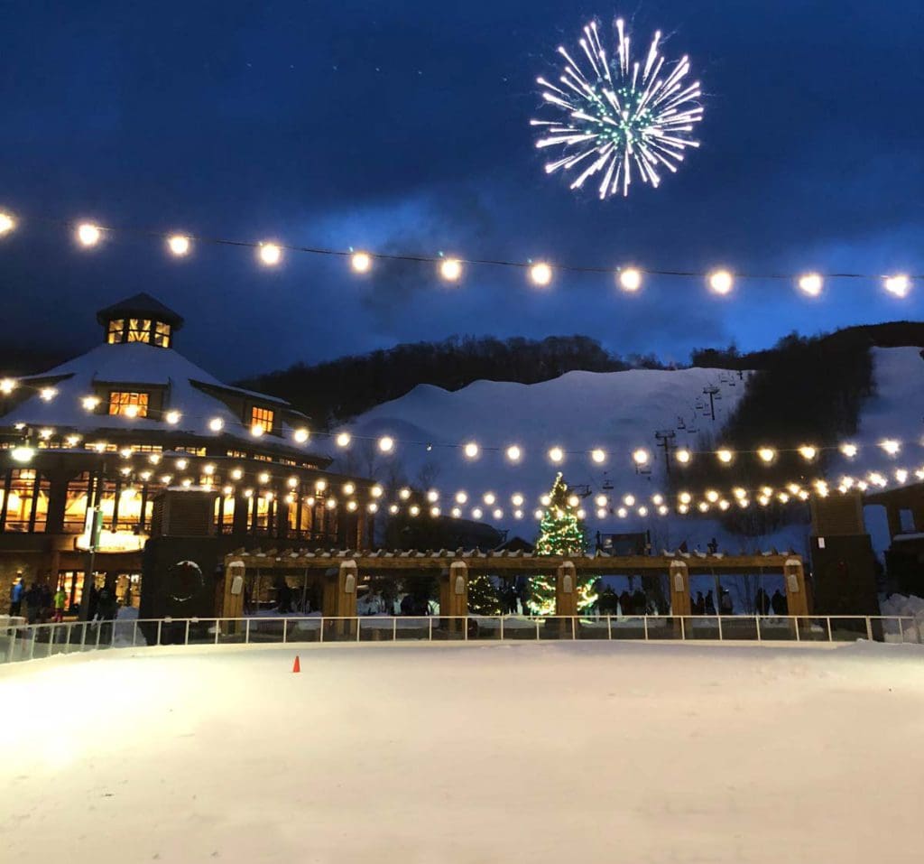 An ice rink nestled under wintery lights in Stowe.