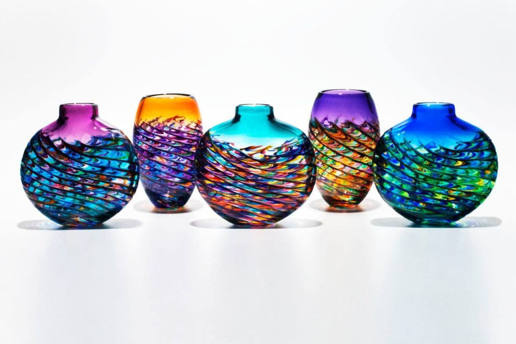 Five glass-blown vases sit on display at Little River HotGlass Studio.