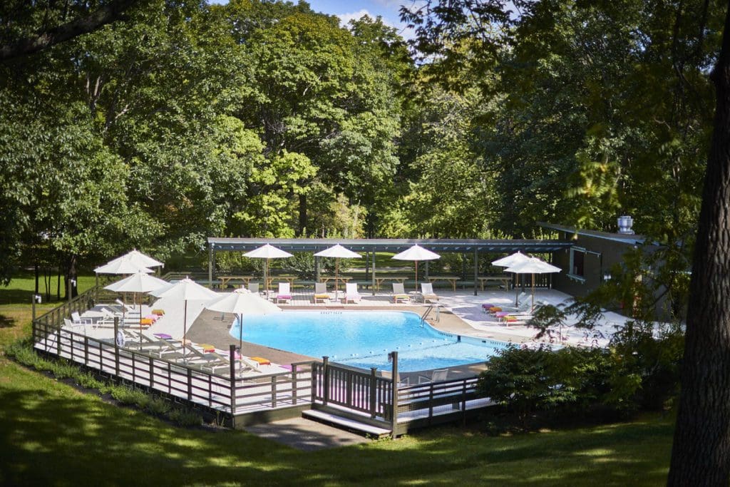 A view of the outdoor pool and surrounding pool deck of Troutbeck.