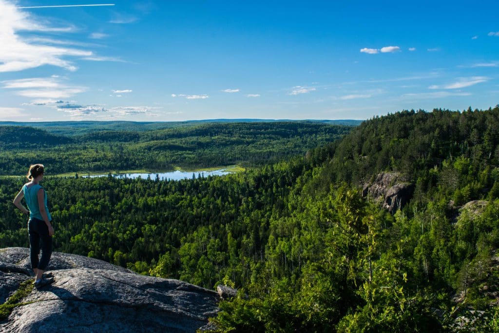 A view from Section 13 of the Superior Hiking Trail, including views of a forested area and a lake in the distance.