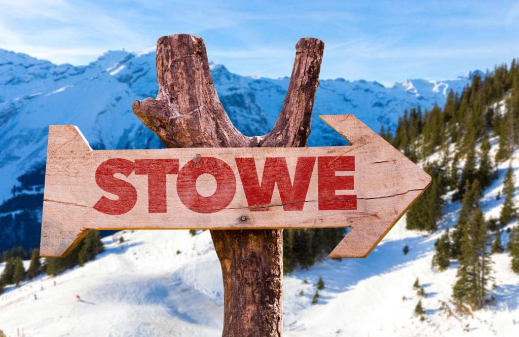 A sign in the mountains reads "Stowe".