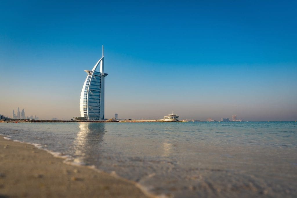 The Burj Khalifa from across a beach, near the ocean, in Dubai, one of the best places to visit in the UAE with kids.