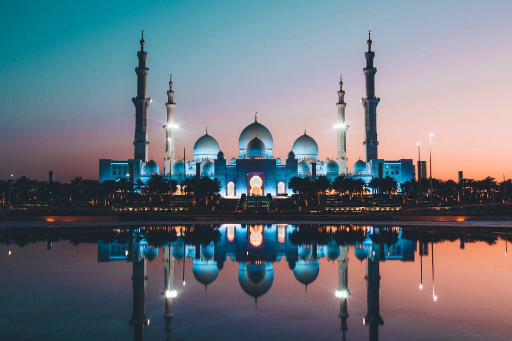 A mosque lit up at night in Abu Dhabi.