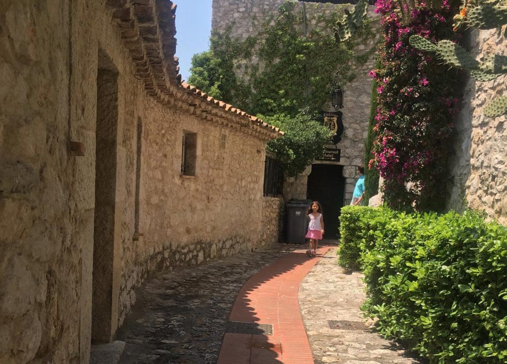 A young girl meanders down a charming road in Eze.