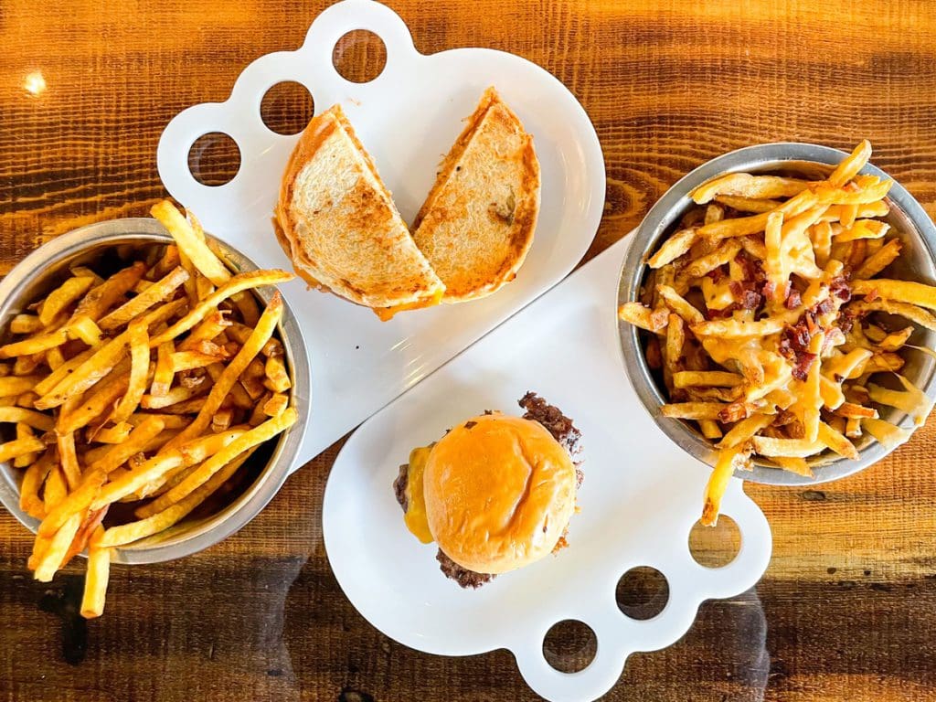 A plate of food from Boise Fry Co., including Idaho potato fries, a burger, and a grilled cheese.