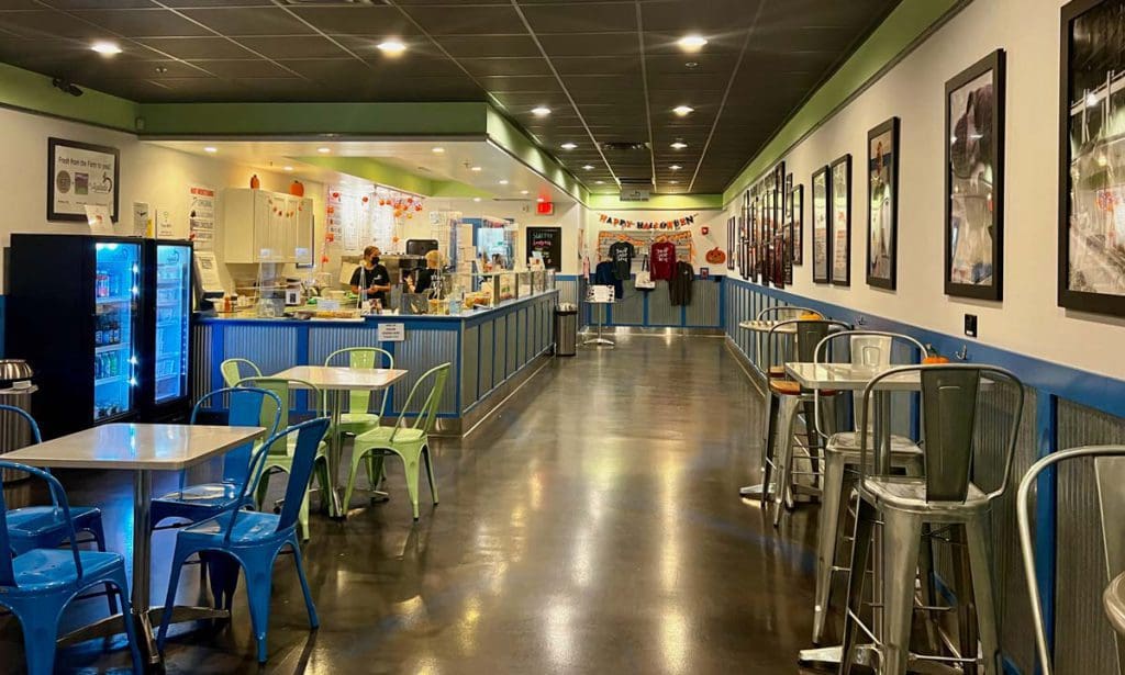 Inside Ayelada's Frozen Yogurt, featuring lots of seating and bright colors, a must eat on this weekend getaway itinerary for families in Pittsfield.
