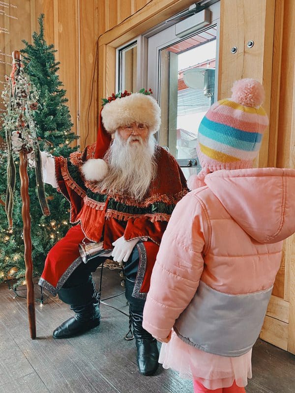 A young girl speaks with Santa at the Frankenmuth Farmers Market ChristKindMarkt.