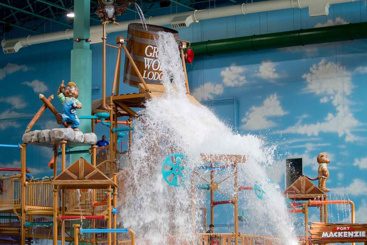 A large bucket of water tips onto a water park feature at Great Wolf Lodge Williamsburg.