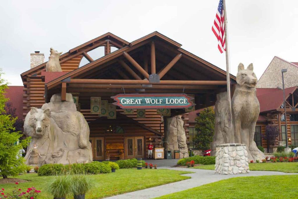 The entrance to Great Wolf Lodge Williamsburg, flanked by large wolf statues on either side.