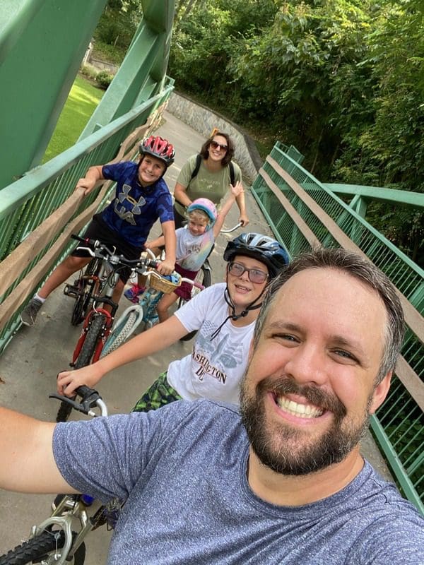 A family takes a selfie while biking along Swamp Rabbit Trail.