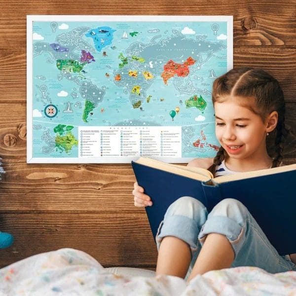 A young girl reads a book, while her Newverest scratch-off map hangs on the wall behind her.